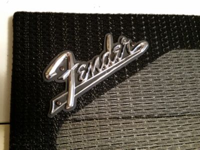 Attach the Fender logo.