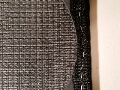 Grille cloth trimmed at hole.