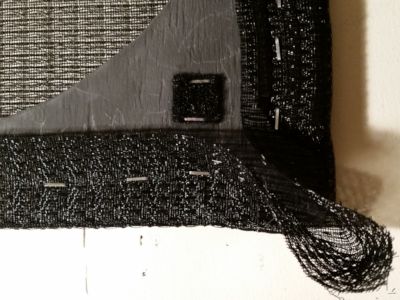 Close look at the grille cloth at a corner.