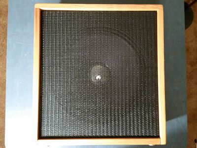 Finished speaker grille frame centered in the opening of the speaker cabinet.